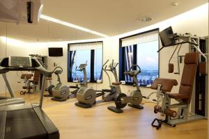 a gym with treadmills and exercise equipment in a building at Hotel Porta Fira 4* Sup in Hospitalet de Llobregat