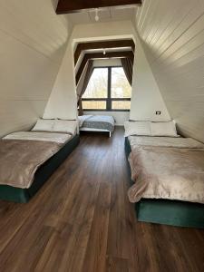 two beds in a room with a window at Meziad-Panorama in Meziad +23 photos