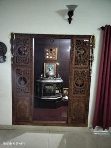 an entrance to a room with a large wooden door at Rajmata Nivas in Kaup