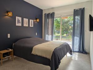 a bedroom with a bed and a large window at Villa Salesiae in Les Salles-sur-Verdon