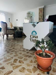 a room with a plant in a pot on a floor at Casa Ligia in Medellín