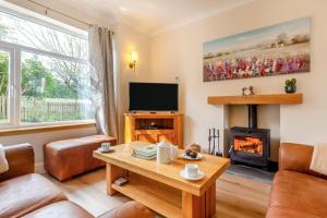 a living room with a fireplace and a tv at 3 Bed in Dingwall oc-m39032 in Dingwall