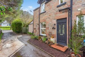a brick house with a black door at 3 Bed in Dingwall oc-m39032 in Dingwall