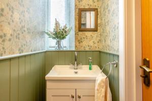 a bathroom with a sink and a vase of flowers at 3 Bed in Dingwall oc-m39032 in Dingwall +35 photos