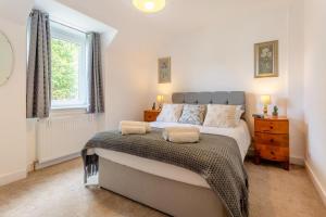 a bedroom with a large bed and a window at 3 Bed in Dingwall oc-m39032 in Dingwall