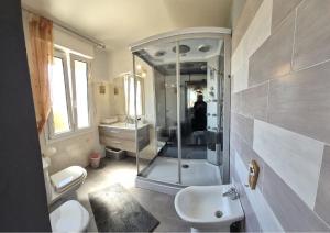 a bathroom with a shower and a toilet and a sink at Relais La Terrazza in Palmadula +24 photos