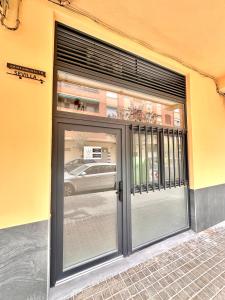 a glass door of a building with a window at Ciudades de España in Valencia
