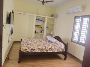 a bedroom with a bed and a tv in it at Raja Accommodation in Kovilpatti