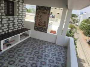 a room with a tile floor and a view at Raja Accommodation in Kovilpatti
