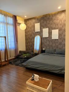 a bedroom with a bed and a mirror and a table at Lita Homestay in Thôn Trường Giang