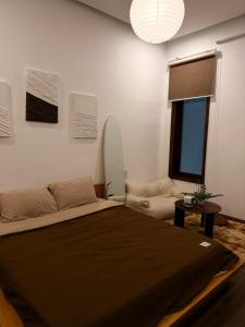 a bedroom with a bed and a living room at Lita Homestay in Thôn Trường Giang