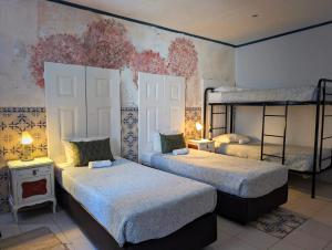 two beds in a room with two bunk beds at RIA Terrace in Faro
