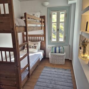 a bedroom with two bunk beds and a window at Villa Giasemi in Spetses +20 photos