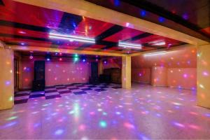 an empty room with pink and purple lights at Hotel Naveen Manali in Manāli +148 photos