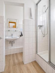 a bathroom with a sink and a shower at Pension Haus Weierts in Norderney +56 photos