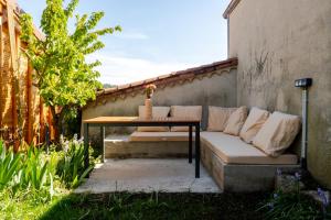 a couch and a table on a patio at Escale victorienne in Saint-Étienne