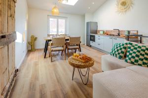 a kitchen and living room with a couch and a table at Escale victorienne in Saint-Étienne +16 photos