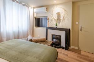 a bedroom with a bed and a fireplace at Escale victorienne in Saint-Étienne