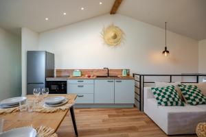 a kitchen and living room with a couch and a table at Escale victorienne in Saint-Étienne