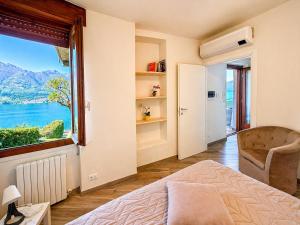 a bedroom with a bed and a large window at Il Bellavista in Lezzeno