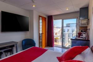 a hotel room with a bed and a large window at Neptuno Aparthotel in Calella