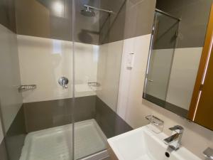 a bathroom with a sink and a glass shower at Vista Point - Cast Renting in Msida +14 photos