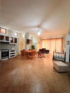 a large living room with a table and chairs at CASA Angelo in Sosúa