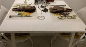 a white table with two plates and a wine glass at Deluxe Queen Room in Perth