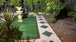 a garden with a green lawn and a fountain at Deluxe Queen Room in Perth