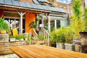 a patio with a wooden table and some plants at City Loft I Fireplace I Free Parking I Garden Bath in Nieuwpoort
