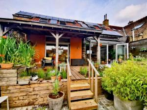 a house with solar panels on the roof at City Loft I Fireplace I Free Parking I Garden Bath in Nieuwpoort