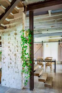 a room with a stone wall with tables and a plant at City Loft I Fireplace I Free Parking I Garden Bath in Nieuwpoort +15 photos