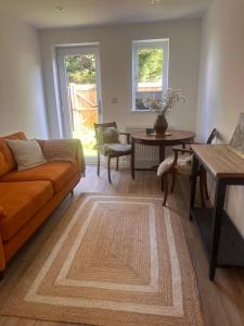 a living room with a couch and a table at Dalforth in Takeley
