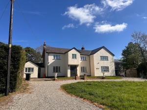 a large white house with a gravel driveway at Dalforth in Takeley
