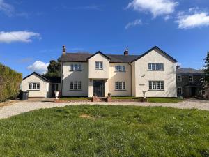 a large white house with a large yard at Dalforth in Takeley