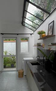 a kitchen with windows and a sink and a counter at Hideaway in Bentota