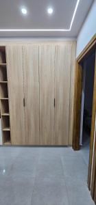a room with wooden cupboards in a house at Maison salakta in Ksour Essaf +1 photo