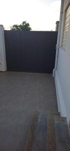 a black fence in front of a patio at Maison salakta in Ksour Essaf
