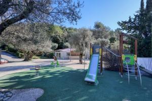 a playground with a slide and a swing at L'Oasis provençale - Joli chalet avec terrasse in Solliès-Toucas