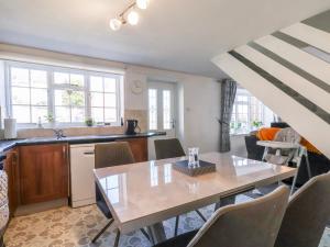 a kitchen and dining room with a table and chairs at Mill View in York