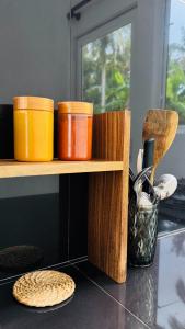 a shelf with four containers on top of a counter at Hideaway in Bentota +10 photos