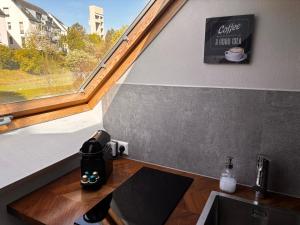 a room with a sink and a window with a coffee maker at Stuttgart Nest in Stuttgart