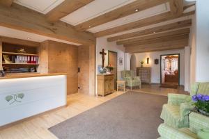 a living room with wooden walls and wooden floors at Hotel Seerose in Rottach-Egern