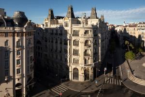 a large white building on a city street at Feelathome Cortes in Madrid
