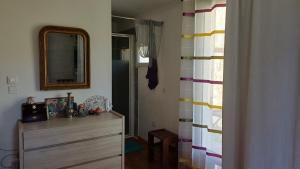 a room with a dresser and a mirror and a dresser at Chambre d'hôte la palud in Barrême