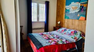 a bedroom with a bed with a quilt on it at Chambre d'hôte la palud in Barrême