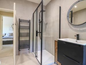 a bathroom with a sink and a mirror at Gardeners Cottage in Oakham +32 photos