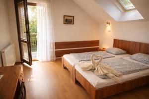 a bedroom with two beds with towels on them at Ekofarma Sádky in Uherské Hradiště