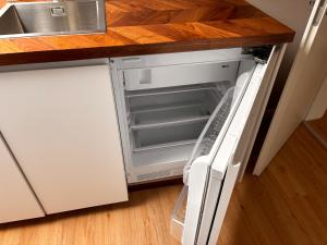 an empty refrigerator with its door open in a kitchen at Stuttgart Nest in Stuttgart +1 photo