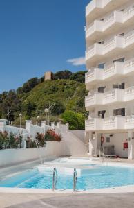 a hotel with a swimming pool in front of a building at Hotel Bernat II 4*Sup in Calella